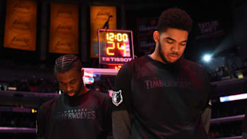 LOS ANGELES, CA - APRIL 9: Andrew Wiggins #22 and Karl-Anthony Towns #32 of the Minnesota Timberwolves stand for the National Anthem before the game against the Los Angeles Lakers on April 9, 2017 at STAPLES Center in Los Angeles, California. NOTE TO USER: User expressly acknowledges and agrees that, by downloading and/or using this Photograph, user is consenting to the terms and conditions of the Getty Images License Agreement. Mandatory Copyright Notice: Copyright 2017 NBAE (Photo by Andrew D. Bernstein/NBAE via Getty Images)