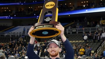 PITTSBURGH, PA - MARCH 23: Bo Nickal of the Penn State Nittany Lions holds the trophy as he celebrates with teammates after winning the team title of the NCAA Wrestling Championships on March 23, 2019 at PPG Paints Arena in Pittsburgh, Pennsylvania. (Photo by Hunter Martin/NCAA Photos via Getty Images)