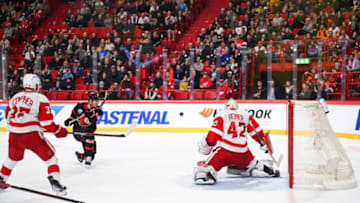 Forward Tim Stutzle (C) of the Ottawa Senators shoots to score the game winning goal in overtime past goaltender James Reimer (R) of the Detroit Red Wings during the NHL Global Series Ice Hockey match between Detroit Red Wings and Ottawa Senators in Stockholm on November 16, 2023. (Photo by Jonathan NACKSTRAND / AFP) (Photo by JONATHAN NACKSTRAND/AFP via Getty Images)