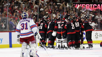RALEIGH, NORTH CAROLINA - MAY 18: Ian Cole #28 of the Carolina Hurricanes scores at 3:12 of overtime against Igor Shesterkin #31 of the New York Rangers in Game One of the Second Round of the 2022 Stanley Cup Playoffs at PNC Arena on May 18, 2022 in Raleigh, North Carolina. The Hurricanes defeated the Rangers 2-1 in overtime. (Photo by Bruce Bennett/Getty Images)