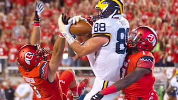 Sep 3, 2015; Salt Lake City, UT, USA; Michigan Wolverines tight end Jake Butt (88) catches a touchdown pass while defended by Utah Utes defensive back Jason Thompson (3) and defensive back Andre Godfrey (7) during the second half at Rice-Eccles Stadium. Utah won 24-17. Mandatory Credit: Russ Isabella-USA TODAY Sports