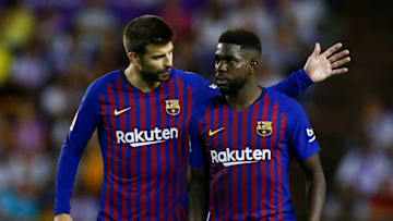 Barcelona's Spanish defender Gerard Pique (L) talks to Barcelona's French defender Samuel Umtiti during the Spanish league football match between Real Valladolid and FC Barcelona at the Jose Zorrilla Stadium in Valladolid on August 25, 2018. (Photo by Benjamin CREMEL / AFP) (Photo credit should read BENJAMIN CREMEL/AFP/Getty Images)