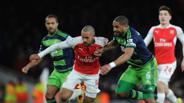 LONDON, ENGLAND - MARCH 02: Theo Walcott of Arsenal is challenged by Ashley Williams of Swansea during the Barclays Premier League match between Arsenal and Swansea City at Emirates Stadium on March 2, 2016 in London, England. (Photo by David Price/Arsenal FC via Getty Images)