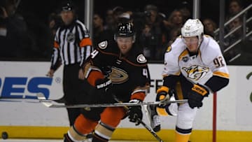Apr 27, 2016; Anaheim, CA, USA; Anaheim Ducks defenseman Cam Fowler (4) and Nashville Predators center Ryan Johansen (92) battle for the puck in game seven of the first round of the 2016 Stanley Cup Playoffs at Honda Center. Mandatory Credit: Kirby Lee-USA TODAY Sports