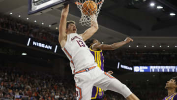 Dec 29, 2021; Auburn, Alabama, USA; Auburn Tigers forward Walker Kessler (13) dunks the ball as LSU Tigers guard Justice Williams (11) defends during the second half Auburn Arena. Mandatory Credit: John Reed-USA TODAY Sports