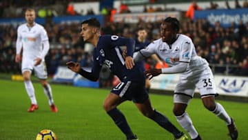 SWANSEA, WALES - JANUARY 02: Erik Lamela (L) of Tottenham Hotspur tracked by Renato Sanches of Swansea City during the Premier League match between Swansea City and Tottenham Hotspur at Liberty Stadium on January 2, 2018 in Swansea, Wales. (Photo by Michael Steele/Getty Images)
