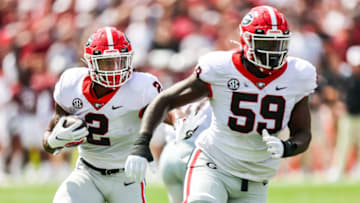 Sep 17, 2022; Columbia, South Carolina, USA; Georgia Bulldogs running back Kendall Milton (2) rushes behind the blocking of Georgia Bulldogs offensive lineman Broderick Jones (59) in the first quarter at Williams-Brice Stadium. Mandatory Credit: Jeff Blake-USA TODAY Sports