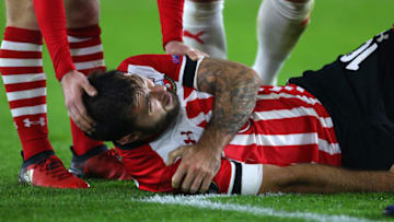 SOUTHAMPTON, ENGLAND - DECEMBER 08: An injured Charlie Austin of Southampton holds his shoulder before he is substituted during the UEFA Europa League match between Southampton FC and Hapoel Beer-Sheva FC at St Mary's Stadium on December 8, 2016 in Southampton, England. (Photo by Catherine Ivill - AMA/Getty Images)