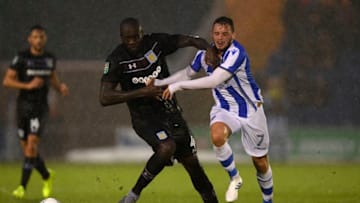 COLCHESTER, ENGLAND - AUGUST 09: Christopher Samba of Aston Villa challenges Drey Wright of Colchester during the Carabao Cup First Round match between Colchester United and Aston Villa at Colchester Community Stadium on August 9, 2017 in Colchester, England. (Photo by Mike Hewitt/Getty Images)