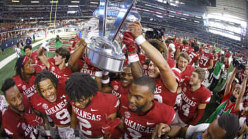 ARLINGTON, TX - SEPTEMBER 25: The Arkansas Razorbacks celebrate with the Southwest Classic championship trophy following the teams 20-10 win over Texas A&M Aggies at AT&T Stadium on September 25, 2021 in Arlington, Texas. (Photo by Ron Jenkins/Getty Images)