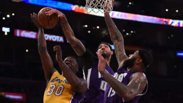 Mar 15, 2016; Los Angeles, CA, USA; Los Angeles Lakers forward Julius Randle (30) is defended by Sacramento Kings center Willie Cauley-Stein (00) and center DeMarcus Cousins (15) during an NBA game at Staples Center. The Kings defeated the Lakers 106-98. Mandatory Credit: Kirby Lee-USA TODAY Sports