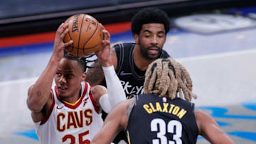 NEW YORK, NEW YORK - MAY 16: Isaac Okoro #35 of the Cleveland Cavaliers drives to the basket as Nicolas Claxton #33 and Kyrie Irving #11 of the Brooklyn Nets defend during the second half against the Brooklyn Nets at Barclays Center on May 16, 2021 in the Brooklyn borough of New York City. The Nets won 123-109. NOTE TO USER: User expressly acknowledges and agrees that, by downloading and or using this photograph, User is consenting to the terms and conditions of the Getty Images License Agreement. (Photo by Sarah Stier/Getty Images)