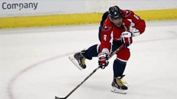 May 4, 2013; Washington, DC, USA; Washington Capitals left wing Alex Ovechkin (8) passes the puck against the New York Rangers in the third period in game two of the first round of the 2013 Stanley Cup playoffs at Verizon Center. Mandatory Credit: Geoff Burke-USA TODAY Sports
