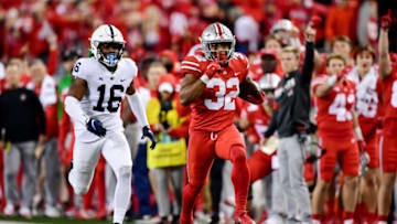 COLUMBUS, OHIO - OCTOBER 30: TreVeyon Henderson #32 of the Ohio State Buckeyes runs the ball past Ji'Ayir Brown #16 of the Penn State Nittany Lions during the second half of their game at Ohio Stadium on October 30, 2021 in Columbus, Ohio. (Photo by Emilee Chinn/Getty Images)