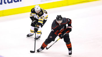 TORONTO, ONTARIO - AUGUST 17: Justin Williams #14 of the Carolina Hurricanes is pursued by Brad Marchand #63 of the Boston Bruins during the second period in Game Four of the Eastern Conference First Round during the 2020 NHL Stanley Cup Playoffs at Scotiabank Arena on August 17, 2020 in Toronto, Ontario. (Photo by Elsa/Getty Images)