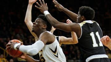 IOWA CITY, IOWA- DECEMBER 29: Forward Tyler Cook #25 of the Iowa Hawkeyes drives to the basket in the second half between guards Adam Grant #11 and Tanner Johnson #21 of the Bryant Bulldogs on December 29, 2018 at Carver-Hawkeye Arena, in Iowa City, Iowa. (Photo by Matthew Holst/Getty Images)