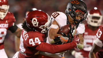 Nov 10, 2018; Norman, OK, USA; Oklahoma State Cowboys running back Chuba Hubbard (30) is tackled by Oklahoma Sooners defensive back Brendan Radley-Hiles (44) during the second half at Gaylord Family - Oklahoma Memorial Stadium. Mandatory Credit: Kevin Jairaj-USA TODAY Sports