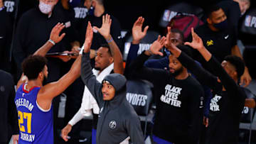 LAKE BUENA VISTA, FLORIDA - AUGUST 30: Jamal Murray #27 of the Denver Nuggets is greeted by teammate on the bench after the Nuggets win against the Utah Jazz in Game Six of the Western Conference First Round during the 2020 NBA Playoffs at AdventHealth Arena at ESPN Wide World Of Sports Complex on August 30, 2020 in Lake Buena Vista, Florida. NOTE TO USER: User expressly acknowledges and agrees that, by downloading and or using this photograph, User is consenting to the terms and conditions of the Getty Images License Agreement. (Photo by Kevin C. Cox/Getty Images)