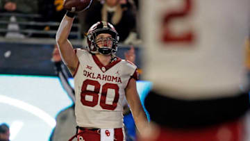 MORGANTOWN, WV - NOVEMBER 23: Grant Calcaterra #80 of the Oklahoma Sooners celebrates after catching a 2 yard touchdown pass in the second half against the West Virginia Mountaineers on November 23, 2018 at Mountaineer Field in Morgantown, West Virginia. (Photo by Justin K. Aller/Getty Images)