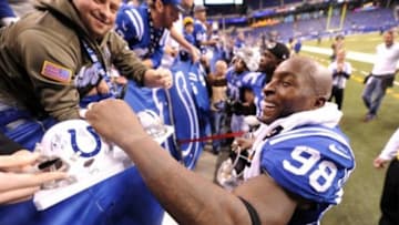 Dec 29, 2013; Indianapolis, IN, USA; Colts line backer Robert Mathis (98) signs autographs after the Colts defeated the Jacksonville Jaguars, 30-10 at Lucas Oil Stadium. Mandatory Credit: Thomas J. Russo-USA TODAY Sports