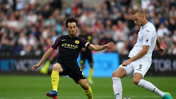 SWANSEA, WALES - SEPTEMBER 24: Swansea player Mike van der Hoorn (r) is challenged by David Silva of Manchester City during the Premier League match between Swansea City and Manchester City at Liberty Stadium on September 24, 2016 in Swansea, Wales. (Photo by Stu Forster/Getty Images)