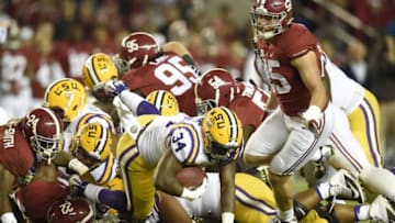 Nov 7, 2015; Tuscaloosa, AL, USA; LSU Tigers running back Darrel Williams (34) is brought down by Alabama Crimson Tide defense during the second quarter at Bryant-Denny Stadium. Mandatory Credit: John David Mercer-USA TODAY Sports