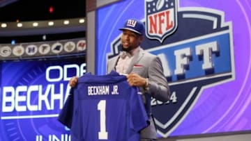 May 8, 2014; New York, NY, USA; Odell Beckham Jr. (LSU) holds up a jersey after being selected as the number twelve overall pick in the first round of the 2014 NFL Draft to the New York Giants at Radio City Music Hall. Mandatory Credit: Adam Hunger-USA TODAY Sports