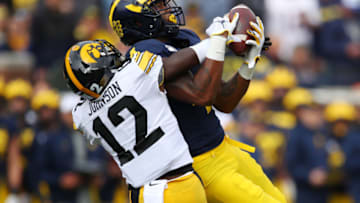 ANN ARBOR, MICHIGAN - OCTOBER 05: Nico Collins #4 of the Michigan Wolverines makes a first quarter catch against D.J. Johnson #12 of the Iowa Hawkeyes at Michigan Stadium on October 05, 2019 in Ann Arbor, Michigan. (Photo by Gregory Shamus/Getty Images)