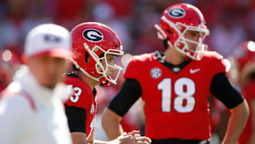 Georgia quarterback Stetson Bennett (13) warms up while Georgia quarterback JT Daniels (18) looks on during warm ups before an NCAA college football game between Kentucky and Georgia in Athens, Ga., on Saturday, Oct. 16, 2021.Syndication Online Athens