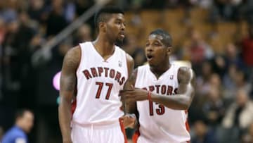 Oct 11, 2013; Toronto, Ontario, CAN; Toronto Raptors point guard Dwight Buycks (13) talks to guard Julyan Stone (77) against the New York Knicks at Air Canada Centre. The Raptors beat the Knicks 100-91. Mandatory Credit: Tom Szczerbowski-USA TODAY Sports
