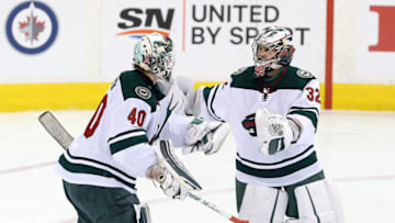 WINNIPEG, MANITOBA - APRIL 20: Alex Stalock #32 of the Minnesota Wild replaces teammate Devan Dubnyk #40 in Game Five of the Western Conference First Round during the 2018 NHL Stanley Cup Playoffs against the Winnipeg Jets on April 20, 2018 at Bell MTS Place in Winnipeg, Manitoba, Canada. (Photo by Jason Halstead /Getty Images)