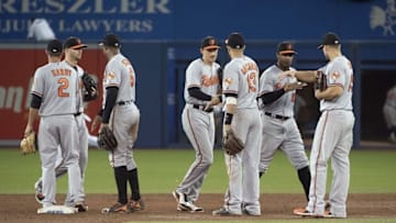 Jul 31, 2016; Toronto, Ontario, CAN; Baltimore Orioles center fielder Adam Jones (10) celebrates the win with Baltimore Orioles first baseman Chris Davis (19) at the end of the twelfth inning in a game against the Toronto Blue Jays at Rogers Centre. The Baltimore Orioles won 6-2. Mandatory Credit: Nick Turchiaro-USA TODAY Sports