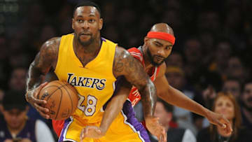 October 26, 2016; Los Angeles, CA, USA; Los Angeles Lakers center Tarik Black (28) controls the ball after stealing the ball from Houston Rockets forward Corey Brewer (33) during the second half at Staples Center. Mandatory Credit: Gary A. Vasquez-USA TODAY Sports