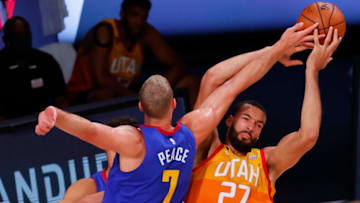 LAKE BUENA VISTA, FLORIDA - AUGUST 30: Mason Plumlee #7 of the Denver Nuggets fouls Rudy Gobert #27 of the Utah Jazz during the second quarter in Game Six of the Western Conference First Round during the 2020 NBA Playoffs at AdventHealth Arena at ESPN Wide World Of Sports Complex on August 30, 2020 in Lake Buena Vista, Florida. NOTE TO USER: User expressly acknowledges and agrees that, by downloading and or using this photograph, User is consenting to the terms and conditions of the Getty Images License Agreement. (Photo by Kevin C. Cox/Getty Images)