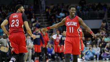 CHARLOTTE, NC - MARCH 11: Teammates Jrue Holiday