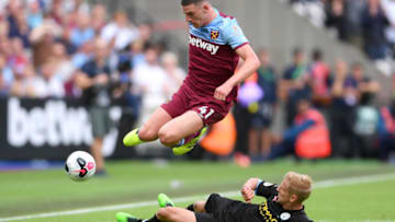 LONDON, ENGLAND - AUGUST 10: Oleksandr Zinchenko of Manchester City tackles Declan Rice of West Ham United during the Premier League match between West Ham United and Manchester City at London Stadium on August 10, 2019 in London, United Kingdom. (Photo by Laurence Griffiths/Getty Images)