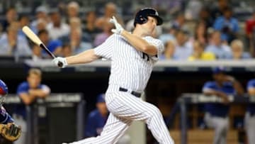 Jul 22, 2014; Bronx, NY, USA; New York Yankees designated hitter Chase Headley (12) strikes out in his first at-bat as a Yankee during the eighth inning of a game against the Texas Rangers at Yankee Stadium. Mandatory Credit: Brad Penner-USA TODAY Sports