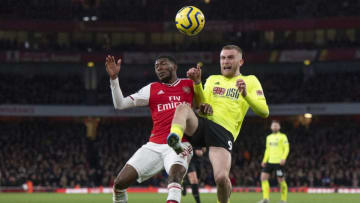 LONDON, ENGLAND - JANUARY 18: Ainsley Maitland-Niles of Arsenal and Oli McBurnie of Sheffield United during the Premier League match between Arsenal FC and Sheffield United at Emirates Stadium on January 18, 2020 in London, United Kingdom. (Photo by Visionhaus)