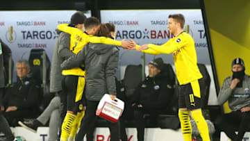 DORTMUND, GERMANY - FEBRUARY 02: Jadon Sancho of Borussia Dortmund interacting with Marco Reus of Borussia Dortmund as he during the DFB Cup Round of Sixteen match between Borussia Dortmund and SC Paderborn 07 at Signal Iduna Park on February 02, 2021 in Dortmund, Germany. Sporting stadiums around Germany remain under strict restrictions due to the Coronavirus Pandemic as Government social distancing laws prohibit fans inside venues resulting in games being played behind closed doors. (Photo by Friedemann Vogel - Pool/Getty Images)