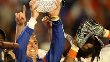 MIAMI - JANUARY 08: Head coach Urban Meyer of the Florida Gators celebrates with the National Championship trophy after therir 24-14 win against the Oklahoma Sooners during the FedEx BCS National Championship game at Dolphin Stadium on January 8, 2009 in Miami, Florida. (Photo by Doug Benc/Getty Images)