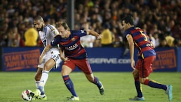 July 21, 2015; Los Angeles, CA, USA; Los Angeles Galaxy defender Leonardo (22) controls the ball against Barcelona midfielder Ivan Rakitic (4) and midfielder Sergio Busquets (5) during the first half at Rose Bowl. Mandatory Credit: Gary A. Vasquez-USA TODAY Sports
