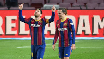 Barcelona's Argentinian forward Lionel Messi (L) celebrates with Barcelona's French midfielder Antoine Griezmann. (Photo by LLUIS GENE/AFP via Getty Images)