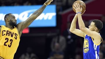 Jun 9, 2015; Cleveland, OH, USA; Golden State Warriors guard Stephen Curry (30) shoots the ball over Cleveland Cavaliers forward LeBron James (23) during the fourth quarter in game three of the NBA Finals at Quicken Loans Arena. Mandatory Credit: Bob Donnan-USA TODAY Sports