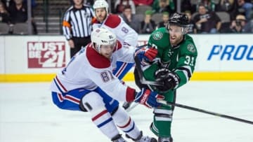 Jan 2, 2014; Dallas, TX, USA; Montreal Canadiens center Lars Eller (81) and Dallas Stars defenseman Alex Goligoski (33) fight for the puck during the first period at the American Airlines Center. Mandatory Credit: Jerome Miron-USA TODAY Sports