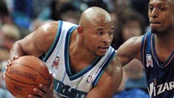 Charlotte Hornets' guard David Wesley (L) looks for room to drive around Washington Wizards' guard Chris Whitney (R) in the second half at the Charlotte Coliseum 05 April 2002 in Charlotte, NC. AFP PHOTO/Nell REDMOND (Photo by NELL REDMOND / AFP) (Photo credit should read NELL REDMOND/AFP via Getty Images)