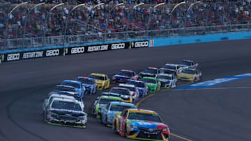PHOENIX, AZ - NOVEMBER 11: Kyle Busch, driver of the #18 M and M's Toyota, and Aric Almirola, driver of the #10 Smithfield Ford (Photo by Sarah Crabill/Getty Images)