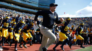 ANN ARBOR, MI - OCTOBER 22: Head coach Jim Harbaugh leads the team onto the field while playing the Illinois Fighting Illini on October 22, 2016 at Michigan Stadium in Ann Arbor, Michigan. Michigan won the game 41-8. (Photo by Gregory Shamus/Getty Images)