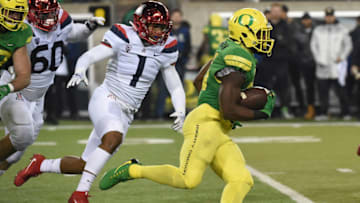 EUGENE, OR - NOVEMBER 18: Running back Royce Freeman #21 of the Oregon Ducks runs with the ball as linebacker Tony Fields II #1 of the Arizona Wildcats closes in during the second half of the game at Autzen Stadium on November 18, 2017 in Eugene, Oregon. The Ducks won the game 48-28. (Photo by Steve Dykes/Getty Images)