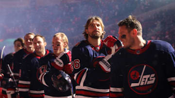 REGINA, SASKATCHEWAN - OCTOBER 26: Blake Wheeler #26 of the Winnipeg Jets and his teammates stand for the singing of the Canadian National Anthem prior to the 2019 Tim Hortons NHL Heritage Classic between the Calgary Flames and the Winnipeg Jets at Mosaic Stadium on October 26, 2019 in Regina, Canada. (Photo by Jonathan Kozub/NHLI via Getty Images)