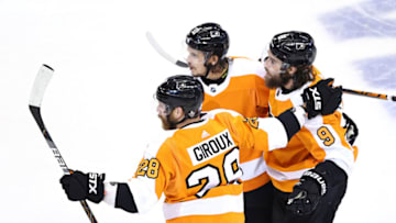 TORONTO, ONTARIO - AUGUST 12: Ivan Provorov #9 of the Philadelphia Flyers is congratulated by teammates Claude Giroux #28 and Travis Konecny #11 after he scored in the first period against the Montreal Canadiens in Game One of the Eastern Conference First Round during the 2020 NHL Stanley Cup Playoffs at Scotiabank Arena on August 12, 2020 in Toronto, Ontario. (Photo by Elsa/Getty Images)